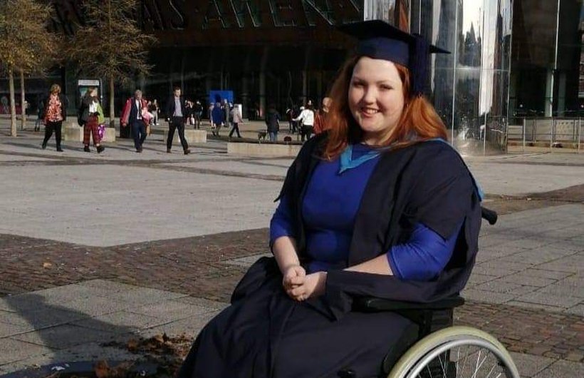 Sophie in her manual wheelchair on her graduation day