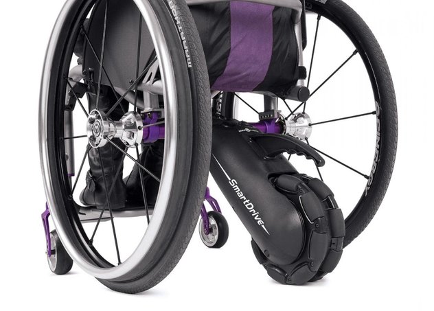 A Smart Drive power add-on attached to the back of a manual wheelchair