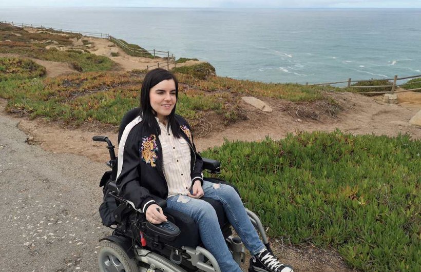 Emma Muldoon in a wheelchair on a cliff path