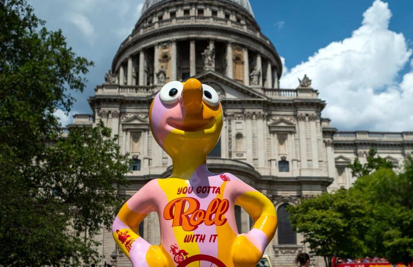 Morph with 'Roll with it' written across his front, standing in front of St Pauls