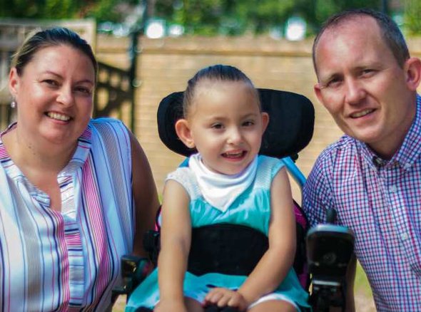 A young wheelchair user with her family