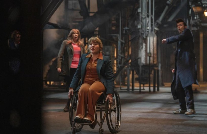 Ruth Madeley as Shirley Anne Bingham in Doctor Who. Her wheelchair has just fired rockets and The Doctor and Donna are in the background, looking shocked.