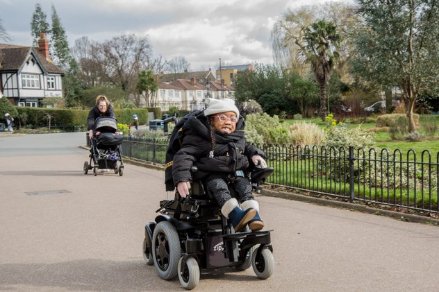 Kiyo-Rei whizzes along a park path in her powered chair