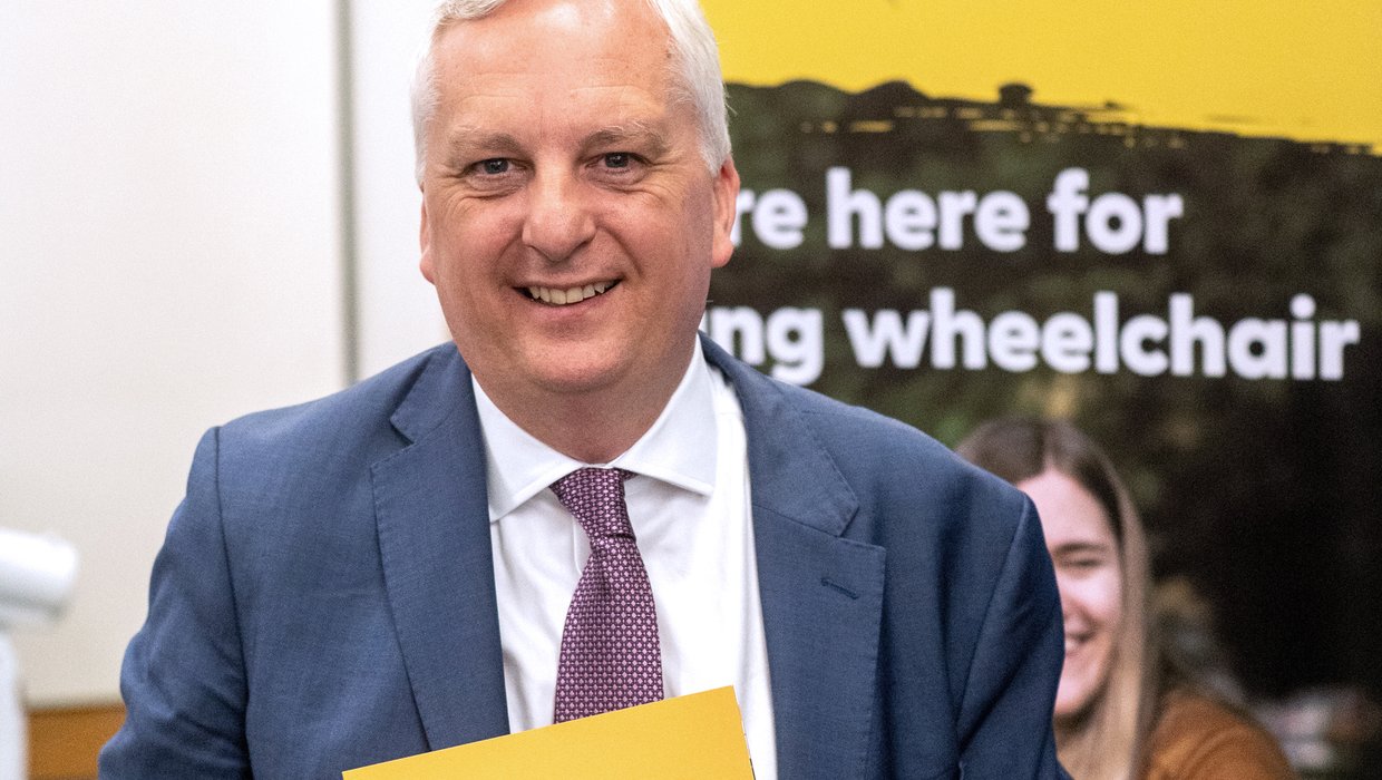 Image of Daniel Francis MP holding the Education report launched in Westminster