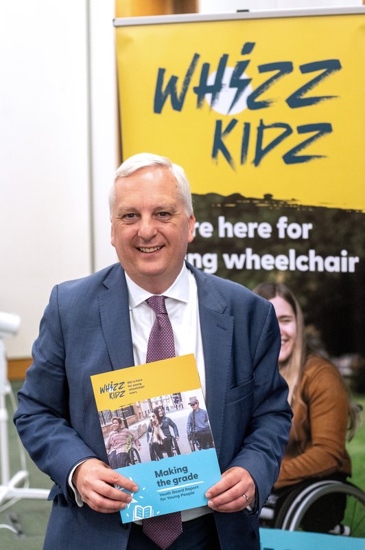 Image of Daniel Francis MP holding the Education report launched in Westminster