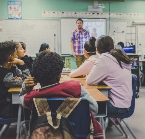 A teacher teaches a class of students