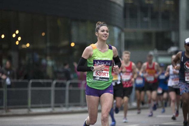A runner in a green Whizz Kidz top during the London Marathon