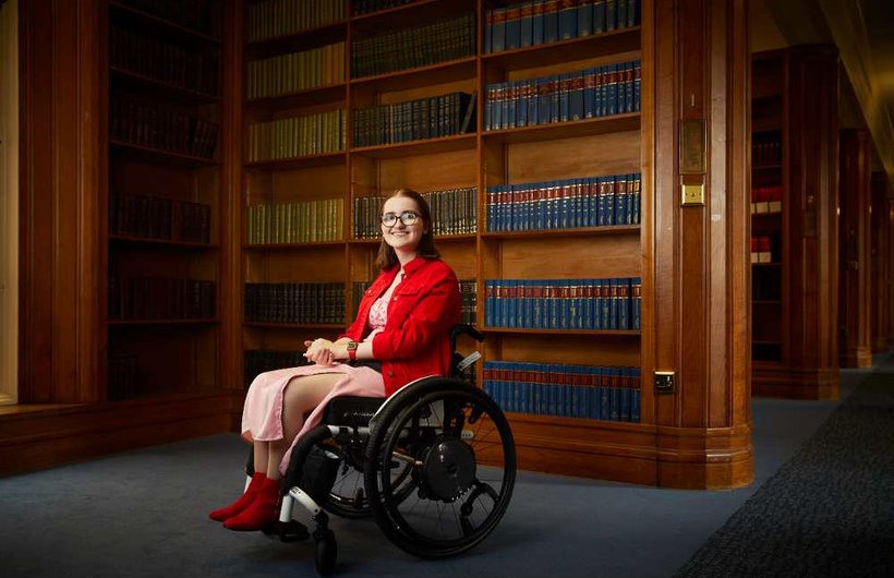 penny in library sitting in wheelchair