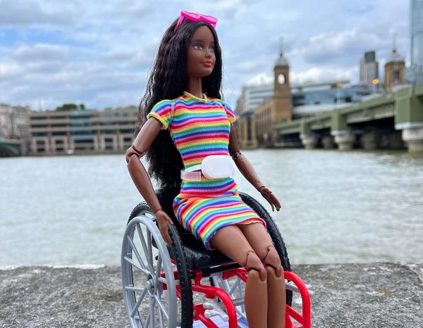 Barbie in a wheelchair in front of the River Thames