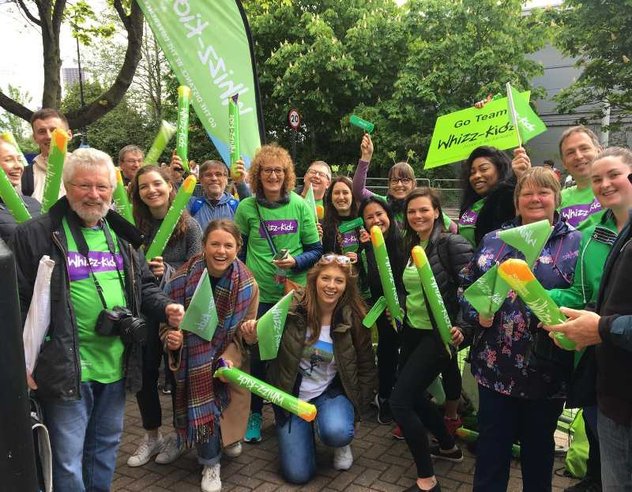 The Whizz Kidz team posing for a picture at a cheer point