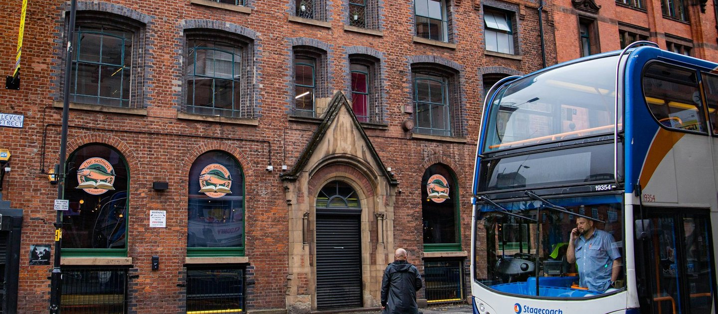 A bus going down a street in Manchester