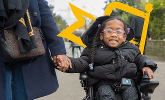 Kiyo-Rei holding her mother's hand as she moves along a pathway in her powered wheelchair